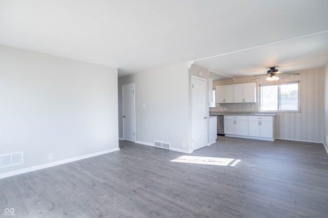 unfurnished living room with ceiling fan and wood-type flooring