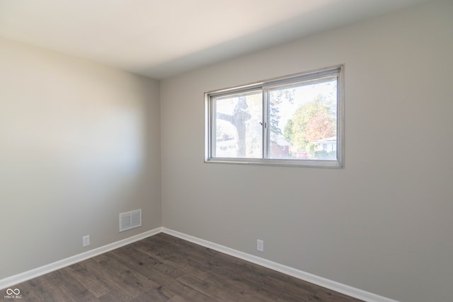 empty room with dark hardwood / wood-style floors