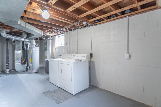 basement featuring water heater, separate washer and dryer, and heating unit