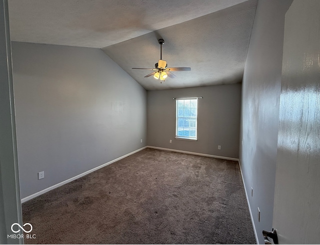 spare room with a textured ceiling, ceiling fan, carpet, and lofted ceiling