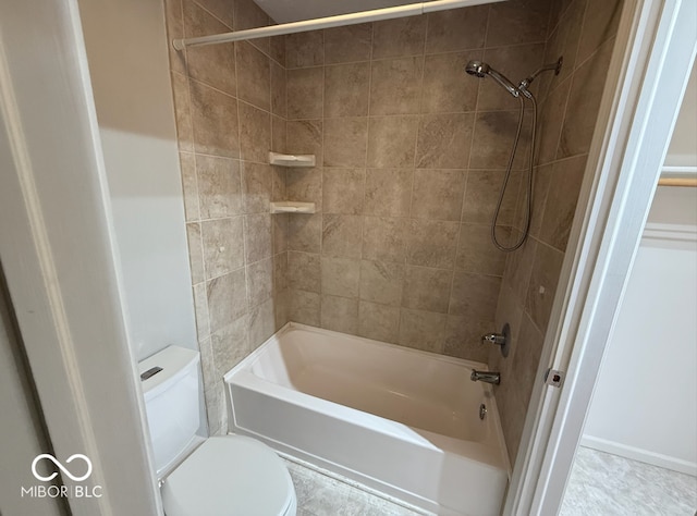 bathroom featuring toilet and tiled shower / bath