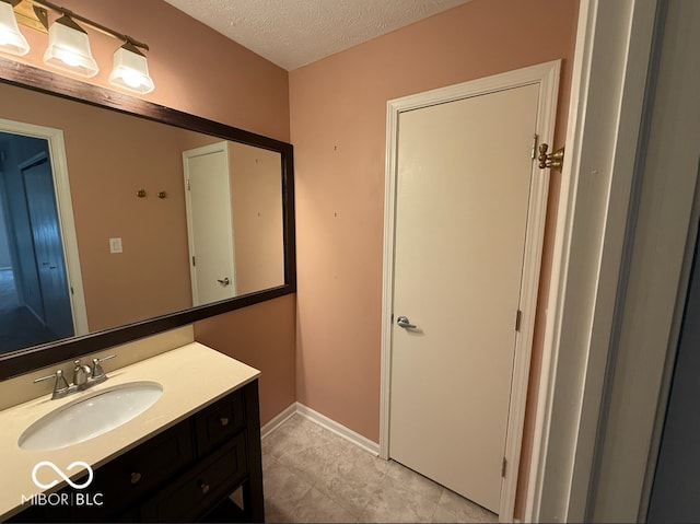 bathroom featuring vanity and a textured ceiling