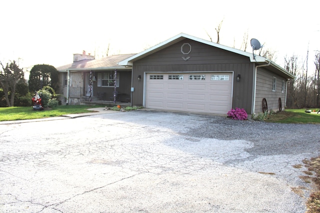 ranch-style home featuring a garage and covered porch