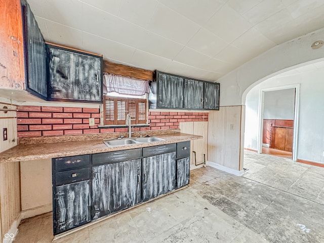 kitchen with wood walls and sink