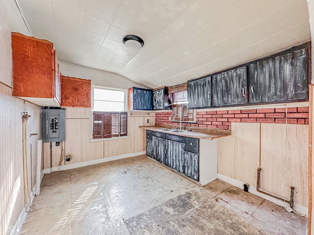 kitchen featuring electric panel, decorative backsplash, lofted ceiling, and sink