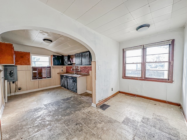 kitchen with lofted ceiling, sink, and backsplash