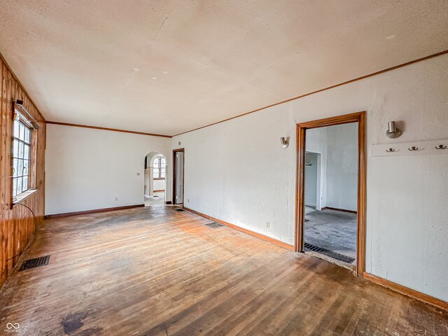 empty room featuring a textured ceiling and hardwood / wood-style flooring