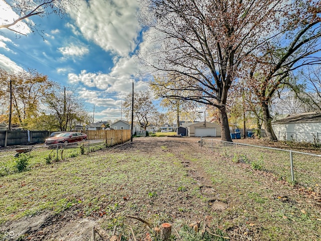 view of yard featuring a garage and an outdoor structure