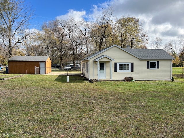 view of side of home featuring a lawn and a storage shed