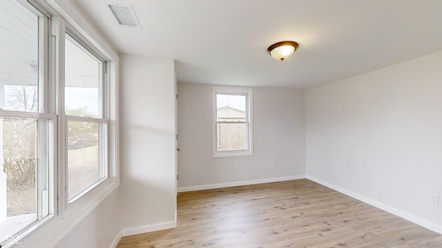 unfurnished room with light hardwood / wood-style flooring