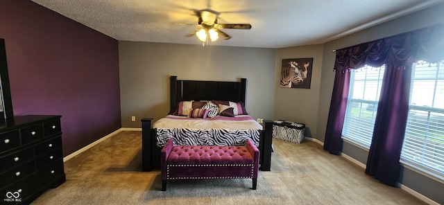 bedroom with a textured ceiling, carpet floors, and ceiling fan