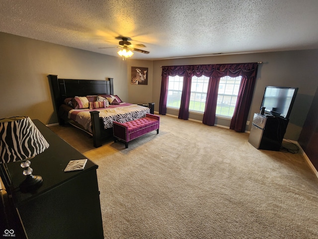 bedroom with carpet floors, a textured ceiling, and ceiling fan