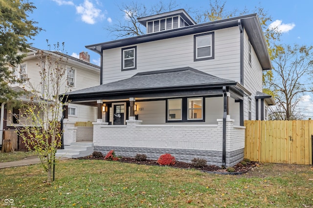 view of front of property with a porch and a front lawn