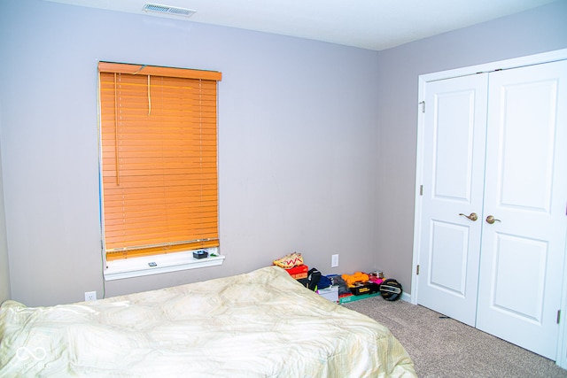 bedroom with carpet and a closet