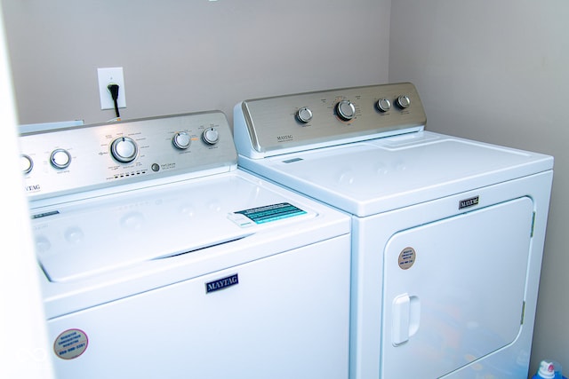 clothes washing area featuring washer and clothes dryer