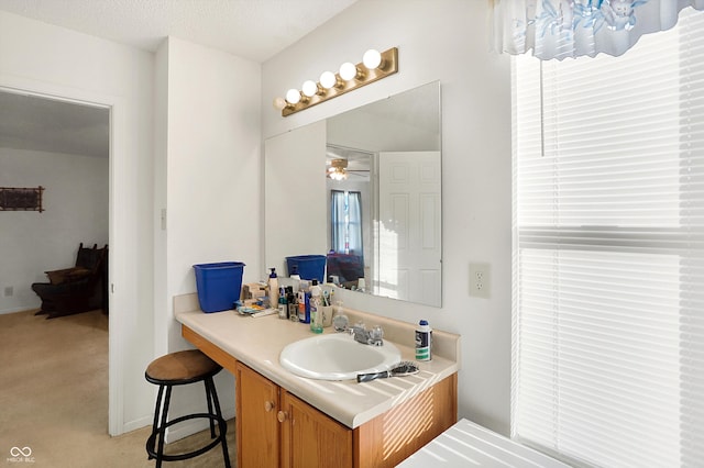 bathroom featuring vanity, a textured ceiling, and ceiling fan