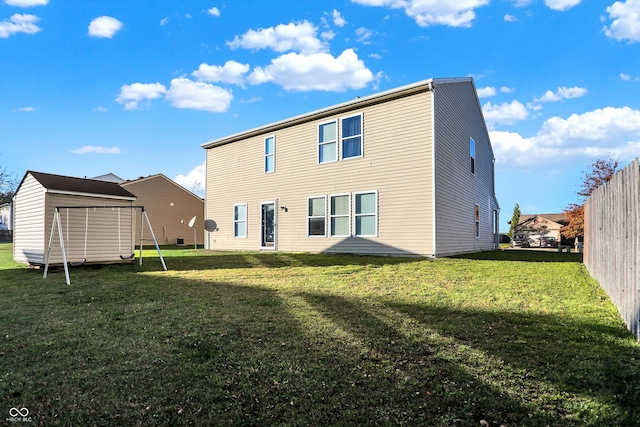 rear view of property featuring a yard