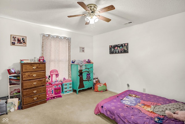 carpeted bedroom featuring a textured ceiling and ceiling fan