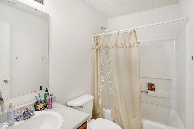 full bathroom with shower / bath combo, vanity, a textured ceiling, and toilet