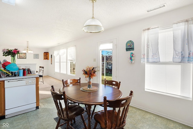 dining area with a textured ceiling and a chandelier