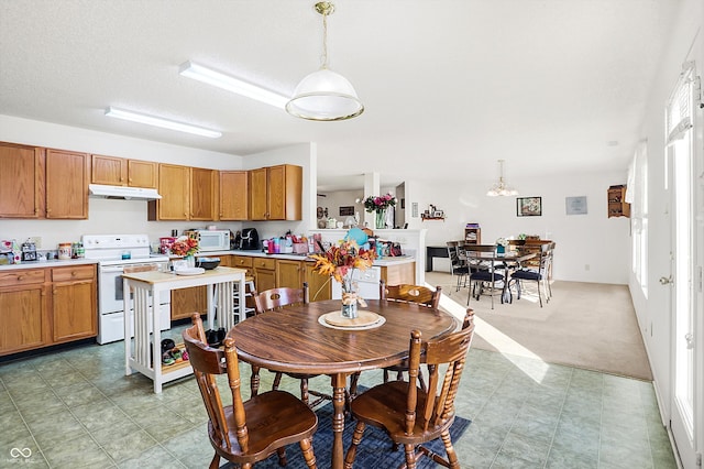 dining room featuring light colored carpet, a textured ceiling, and a notable chandelier