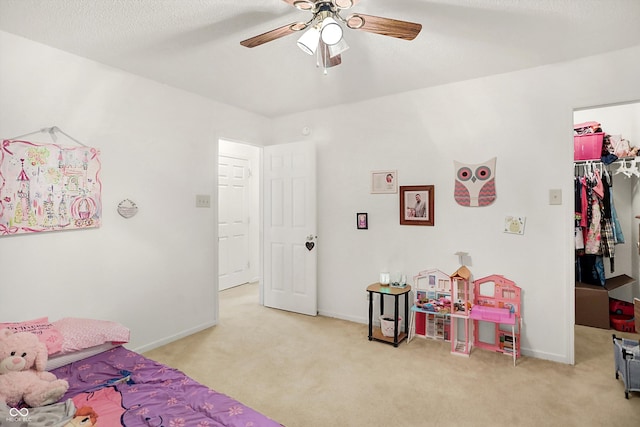 bedroom with a closet, light carpet, and ceiling fan