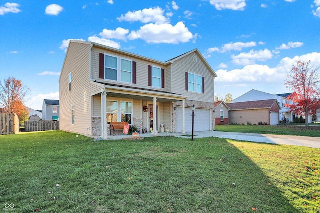 view of front property featuring a garage, a front yard, and a porch