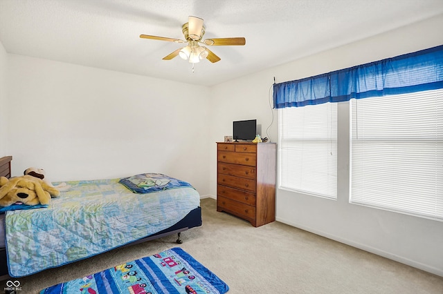 carpeted bedroom featuring ceiling fan