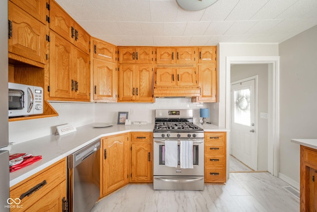 kitchen featuring premium range hood, stainless steel appliances, and tasteful backsplash