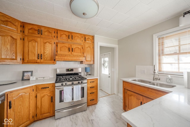 kitchen featuring black dishwasher, sink, decorative backsplash, custom exhaust hood, and gas stove