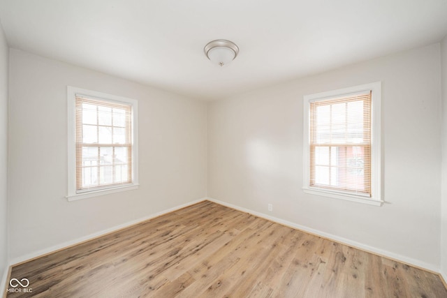 spare room with a healthy amount of sunlight and light hardwood / wood-style floors