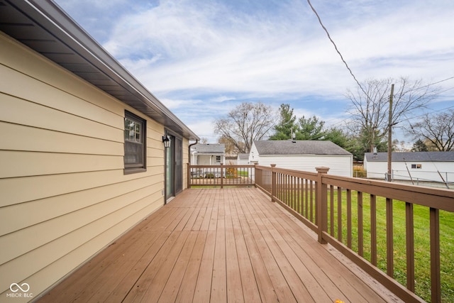 wooden deck featuring a lawn