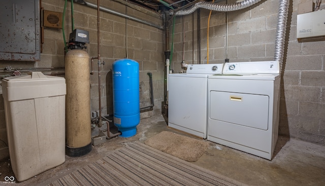 clothes washing area with washing machine and dryer