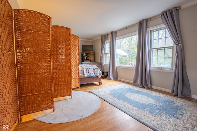 unfurnished bedroom featuring hardwood / wood-style flooring and crown molding