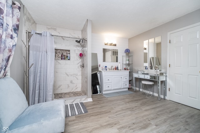 bathroom featuring a textured ceiling, vanity, and hardwood / wood-style flooring