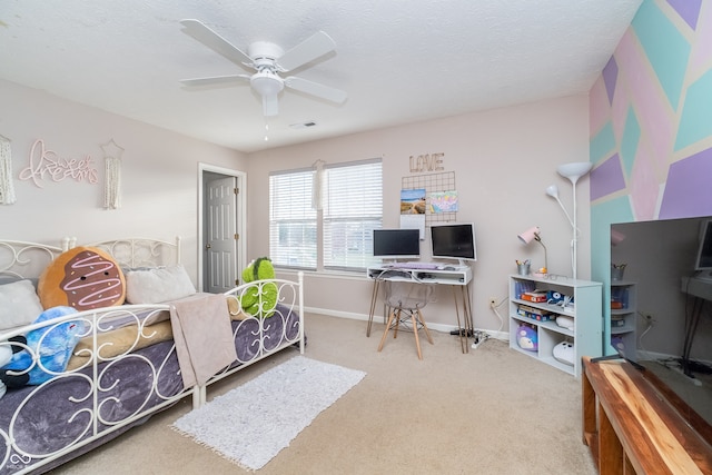 bedroom with ceiling fan, a textured ceiling, and carpet flooring