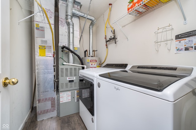 laundry area featuring dark hardwood / wood-style floors, gas water heater, and separate washer and dryer