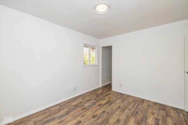 spare room featuring dark wood-type flooring