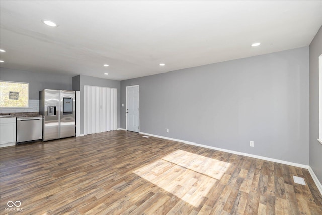 unfurnished living room featuring hardwood / wood-style flooring