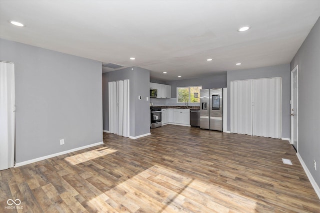 unfurnished living room featuring hardwood / wood-style flooring