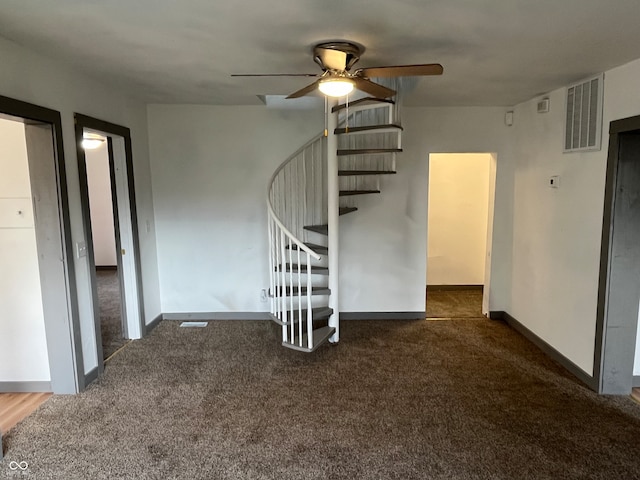 unfurnished room featuring ceiling fan and dark carpet