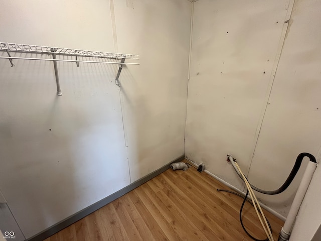 laundry area with wood-type flooring