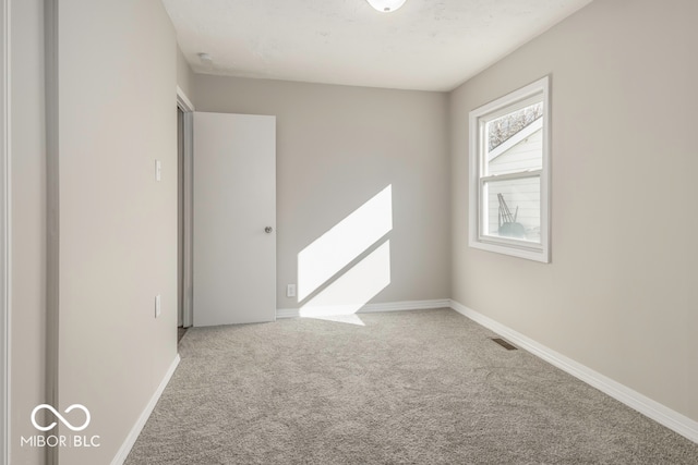 unfurnished room featuring carpet flooring