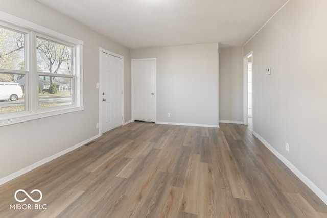 empty room with hardwood / wood-style floors