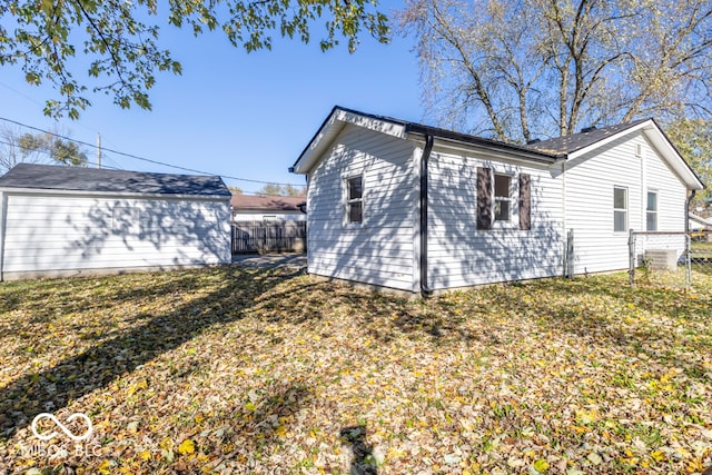 view of side of home with a yard