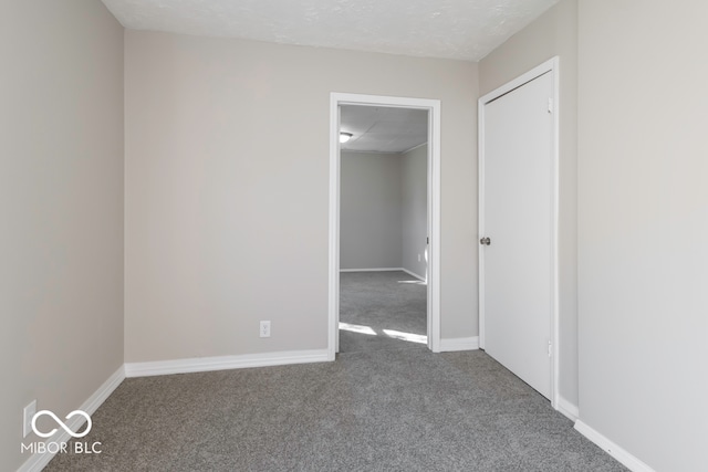 carpeted spare room with a textured ceiling