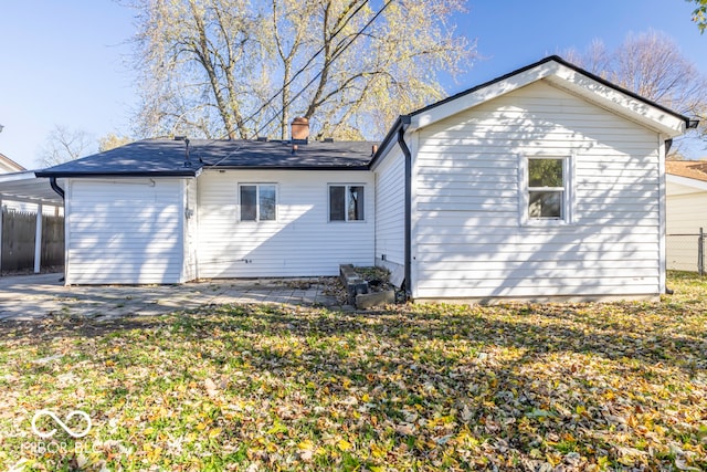 rear view of house featuring a lawn