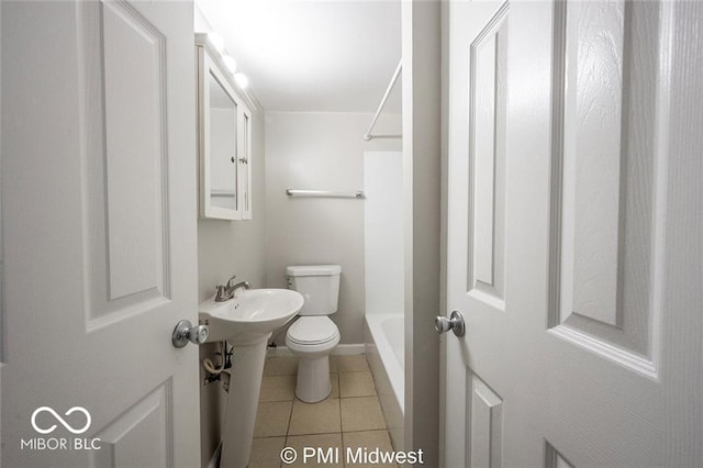 bathroom with toilet and tile patterned flooring