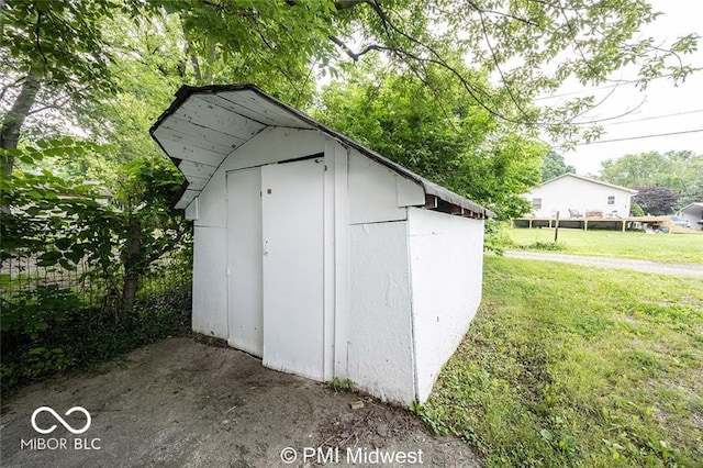 view of outbuilding featuring a lawn