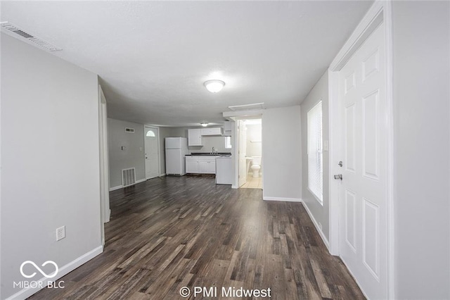 unfurnished living room featuring dark hardwood / wood-style floors